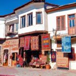 Discover an antique shop with vibrant traditional rugs in a historic setting, perfect for decor inspiration.